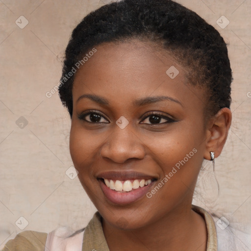 Joyful black young-adult female with short  brown hair and brown eyes