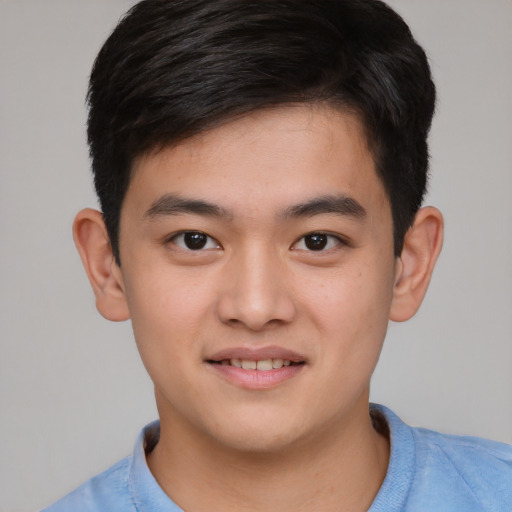 Joyful asian child male with short  brown hair and brown eyes