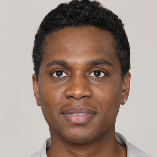 Joyful black young-adult male with short  black hair and brown eyes