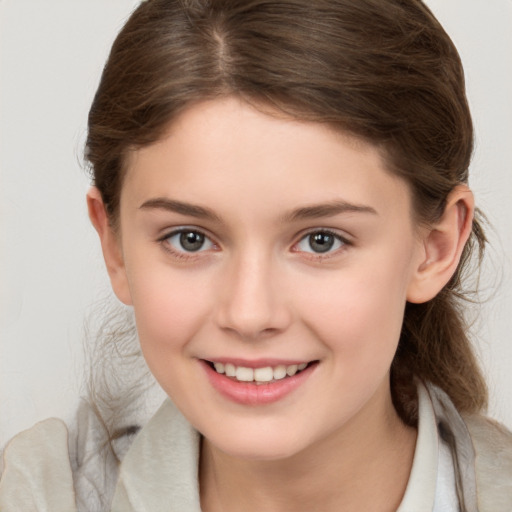 Joyful white child female with medium  brown hair and brown eyes