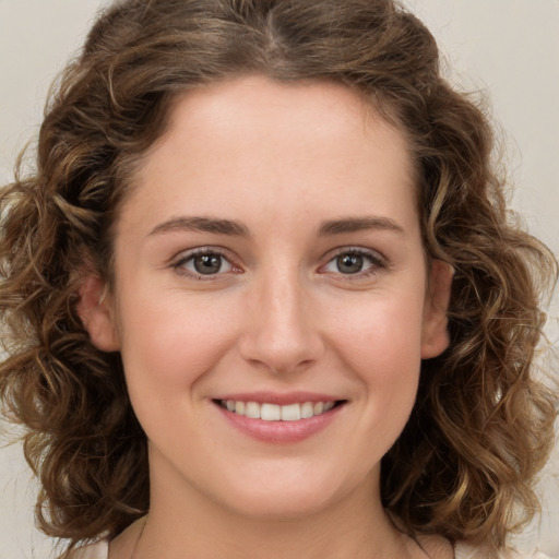 Joyful white young-adult female with medium  brown hair and green eyes