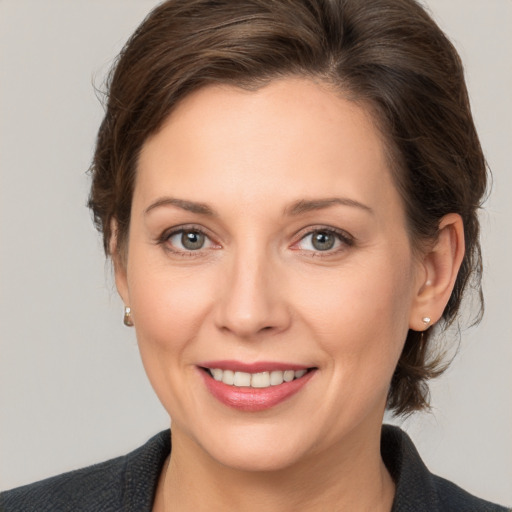 Joyful white adult female with medium  brown hair and brown eyes