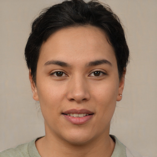 Joyful latino young-adult female with short  brown hair and brown eyes