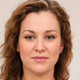 Joyful white young-adult female with long  brown hair and green eyes