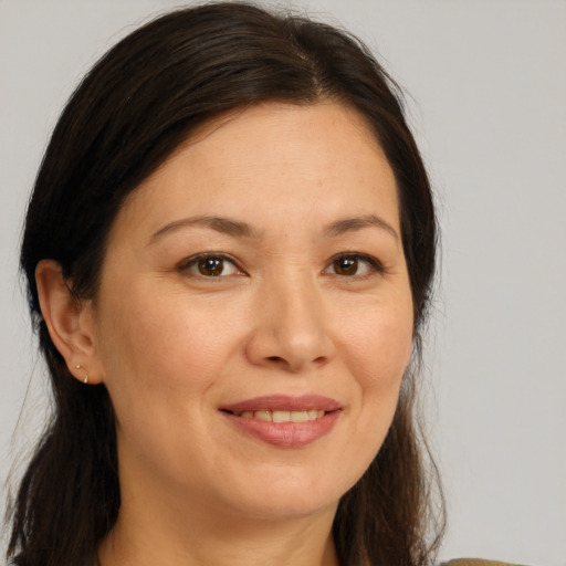 Joyful white adult female with long  brown hair and brown eyes