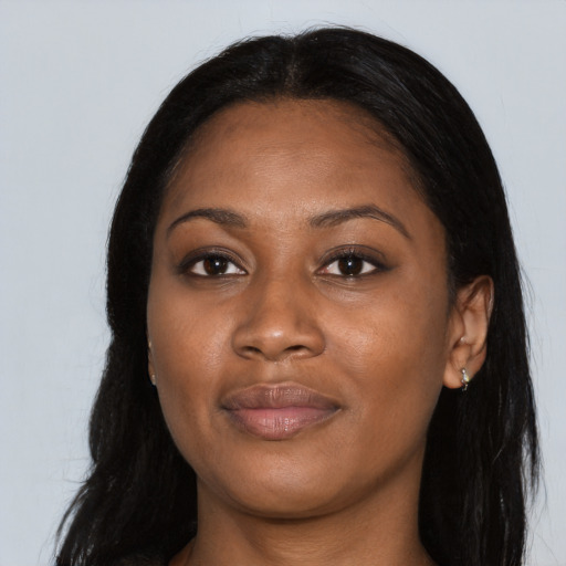 Joyful black young-adult female with long  black hair and brown eyes