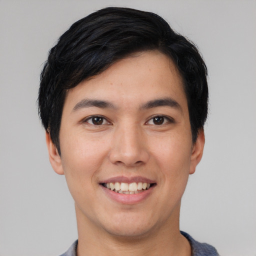 Joyful asian young-adult male with short  black hair and brown eyes