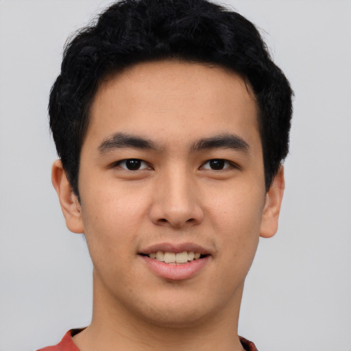 Joyful asian young-adult male with short  black hair and brown eyes