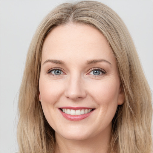 Joyful white young-adult female with long  brown hair and blue eyes