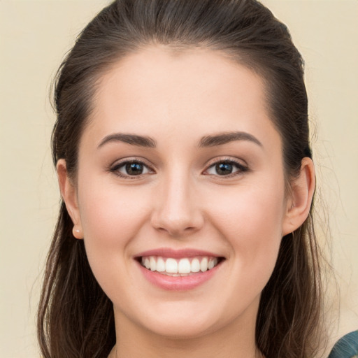 Joyful white young-adult female with long  brown hair and brown eyes