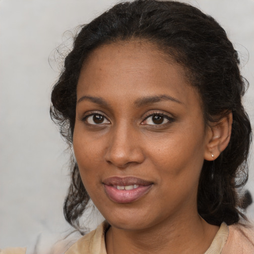 Joyful black young-adult female with medium  brown hair and brown eyes