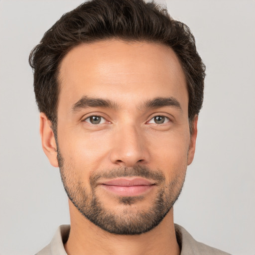 Joyful white young-adult male with short  brown hair and brown eyes