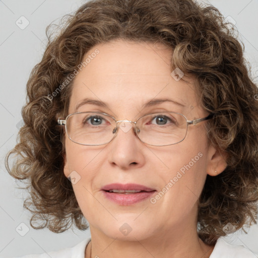 Joyful white adult female with medium  brown hair and green eyes