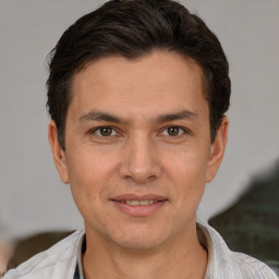 Joyful white adult male with short  brown hair and brown eyes