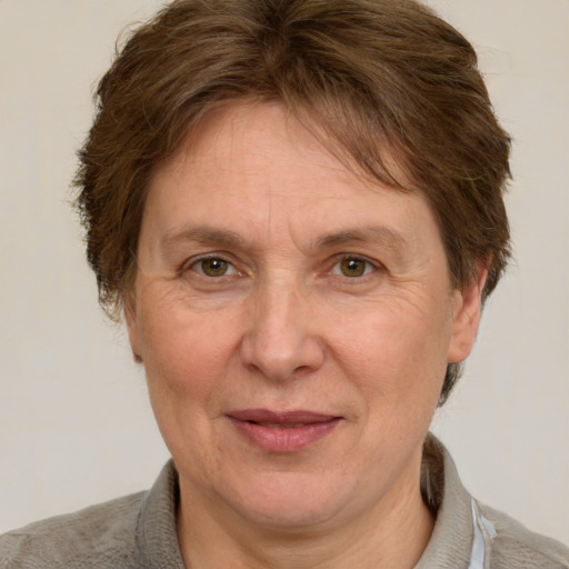 Joyful white adult female with short  brown hair and grey eyes