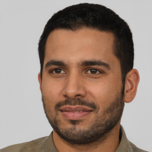 Joyful latino young-adult male with short  black hair and brown eyes