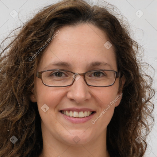 Joyful white adult female with long  brown hair and brown eyes