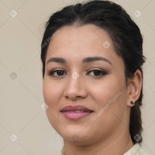 Joyful latino young-adult female with medium  brown hair and brown eyes