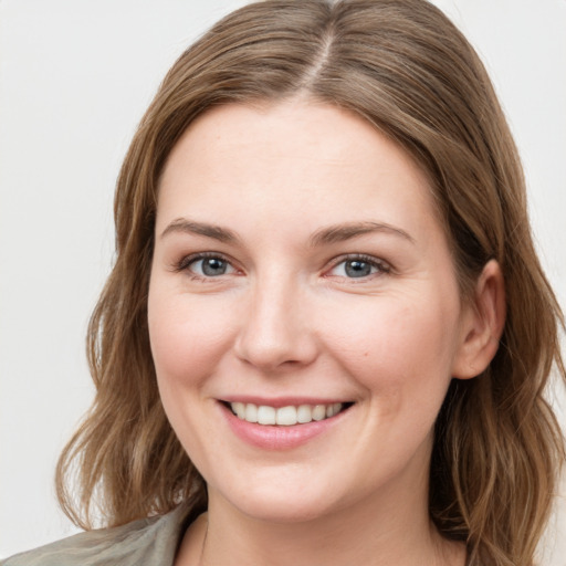 Joyful white young-adult female with medium  brown hair and green eyes