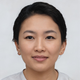 Joyful asian young-adult female with short  black hair and brown eyes