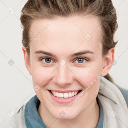 Joyful white young-adult female with short  brown hair and blue eyes