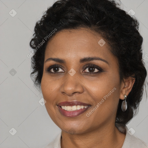 Joyful black adult female with medium  brown hair and brown eyes