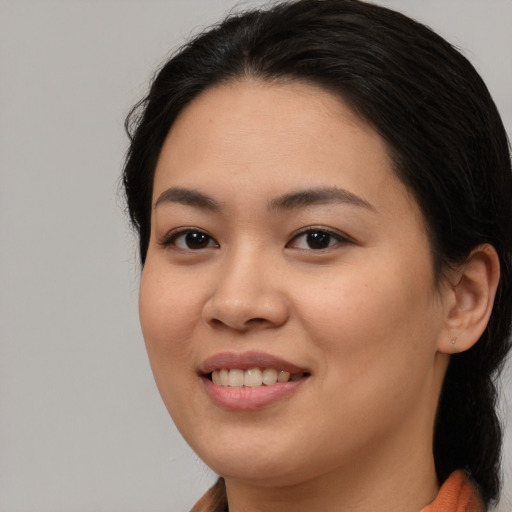 Joyful asian young-adult female with long  brown hair and brown eyes
