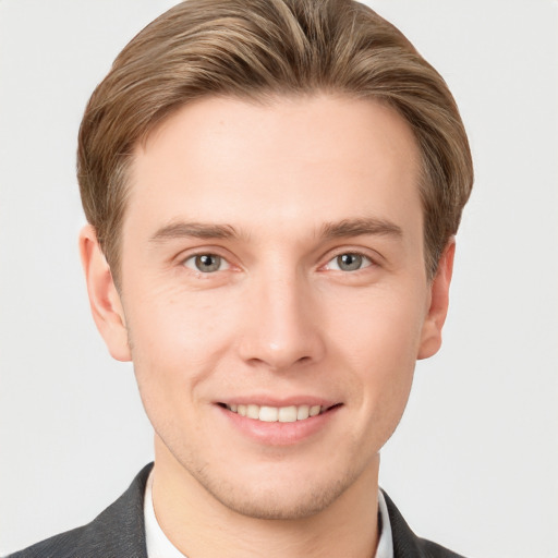 Joyful white young-adult male with short  brown hair and grey eyes