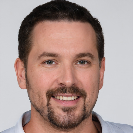 Joyful white adult male with short  brown hair and brown eyes