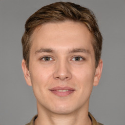 Joyful white young-adult male with short  brown hair and grey eyes