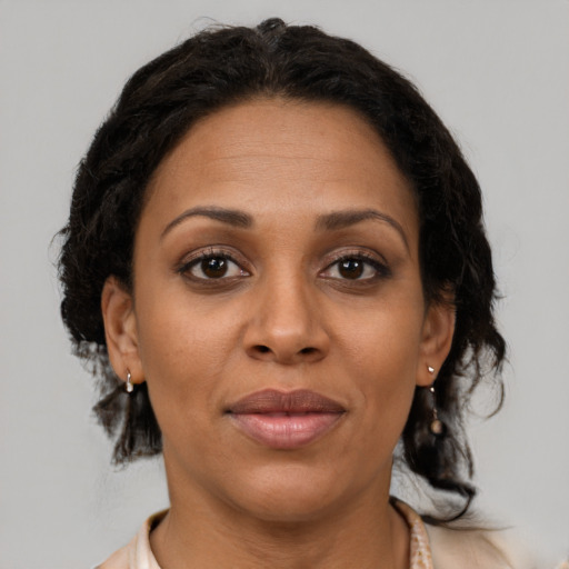 Joyful black young-adult female with medium  brown hair and brown eyes
