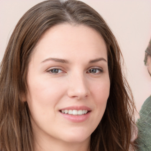 Joyful white young-adult female with long  brown hair and grey eyes