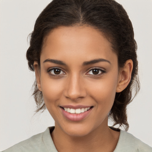 Joyful latino young-adult female with medium  brown hair and brown eyes