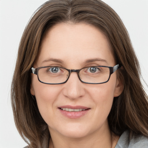 Joyful white young-adult female with medium  brown hair and grey eyes