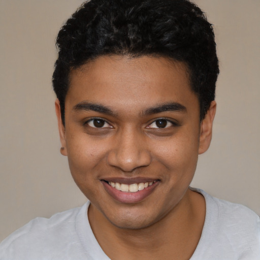 Joyful latino young-adult male with short  brown hair and brown eyes