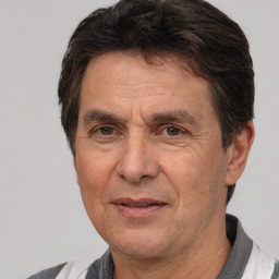 Joyful white middle-aged male with short  brown hair and brown eyes