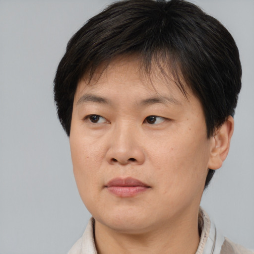 Joyful asian young-adult female with short  brown hair and brown eyes