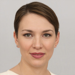 Joyful white young-adult female with short  brown hair and grey eyes