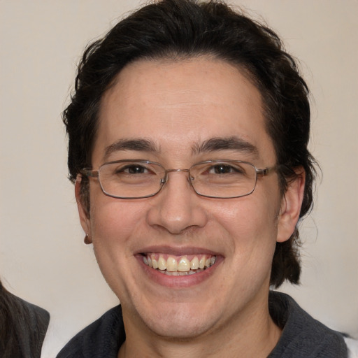 Joyful white adult male with medium  brown hair and brown eyes