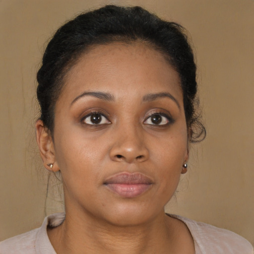 Joyful black young-adult female with short  brown hair and brown eyes