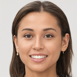 Joyful white young-adult female with long  brown hair and brown eyes