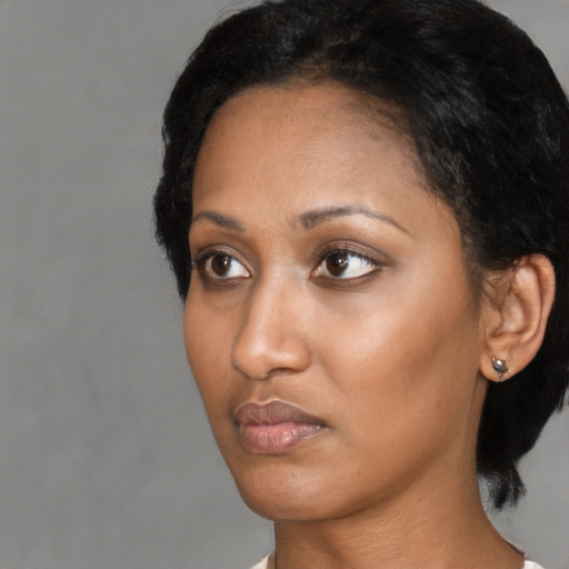 Neutral black young-adult female with short  black hair and brown eyes