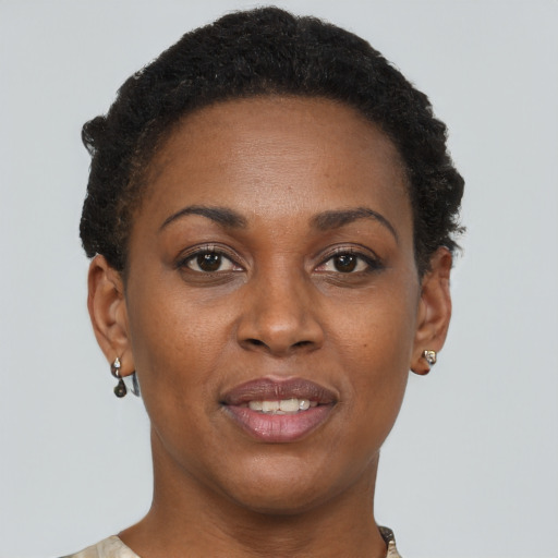 Joyful black adult female with short  brown hair and brown eyes