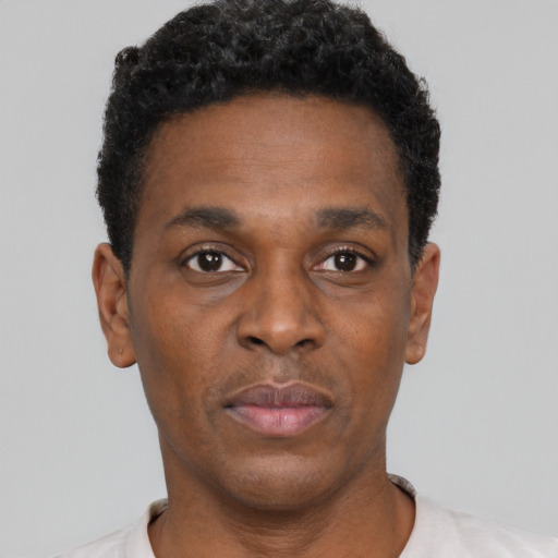 Neutral black young-adult male with short  black hair and brown eyes