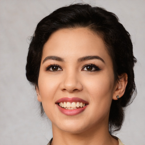 Joyful latino young-adult female with medium  black hair and brown eyes