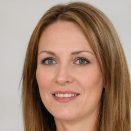 Joyful white adult female with long  brown hair and brown eyes