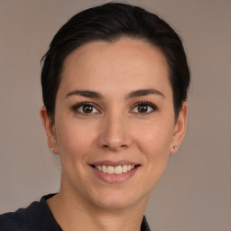 Joyful white young-adult female with medium  brown hair and brown eyes