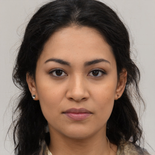 Joyful latino young-adult female with long  black hair and brown eyes
