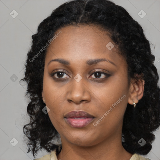 Joyful black young-adult female with long  black hair and brown eyes