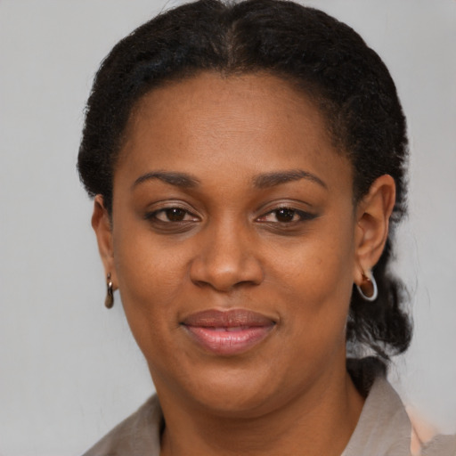 Joyful black adult female with short  brown hair and brown eyes